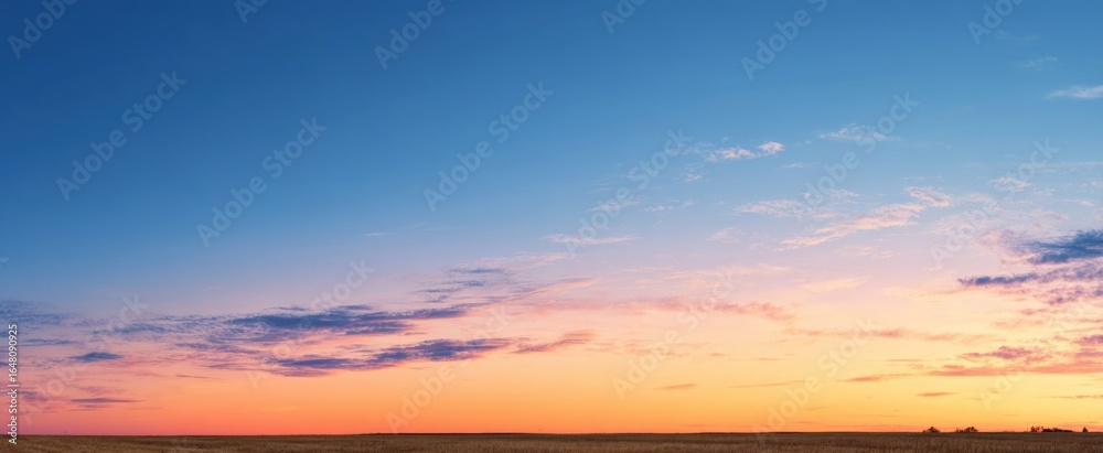 Obraz premium The Sunset Sky Over Wide Open Prairie with Soft Pastel Clouds and Horizon