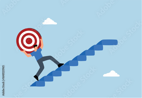 strong businessman carrying big target on his shoulder going up the stairs.