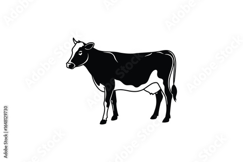 A black and white cow standing in profile silhouette