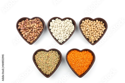 Different type of raw dry legumes composition.   lentils, red lentils, chickpeas and kidney beans. Mix organic legume concept. With Heart shape bowl.