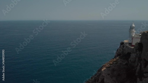 Lighthouse on Rocky Cliff Overlooking Mediterranean Sea in Spain