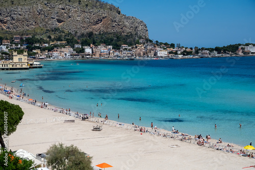 Fototapeta Naklejka Na Ścianę i Meble -  Sunny day on seaside vacation destination, Mondello Beach, near Palermo in Sicily with fine, golden sand, turquoise waters and charming villas, South of Italy