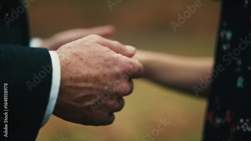 Two people holding hands in an emotional moment.