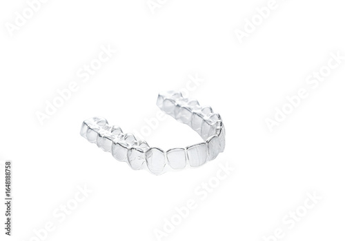 Clear Invisalign dental aligner on black background highlighting orthodontic treatment