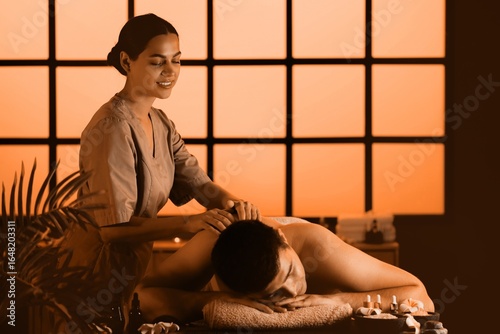 Female therapist massaging ...