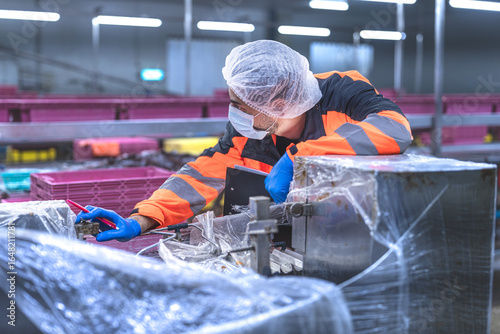 Food and manufacturing researchers oversee seafood production lines in tightly controlled factories where machinery is used to produce and cook food before it is shipped out.
