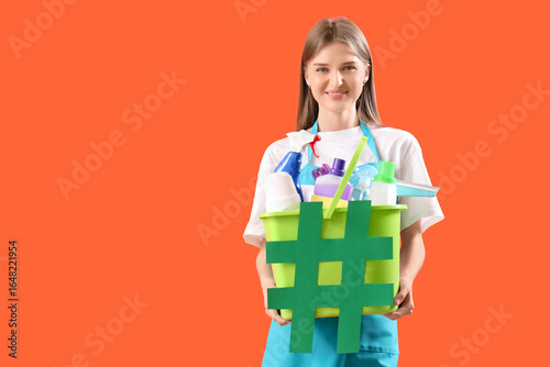 Female janitor holding buck...