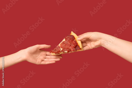 Female hand giving tasty pi...