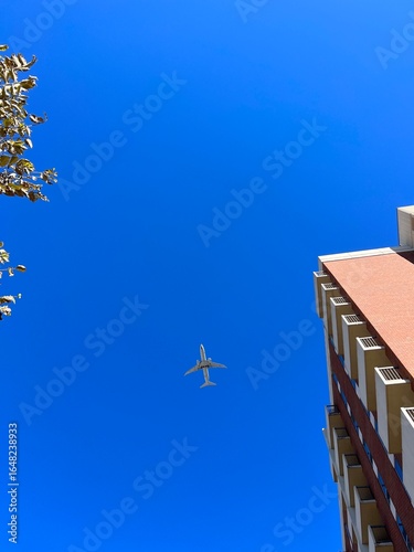 Airplane Flying Overhead in Clear Blue Sky