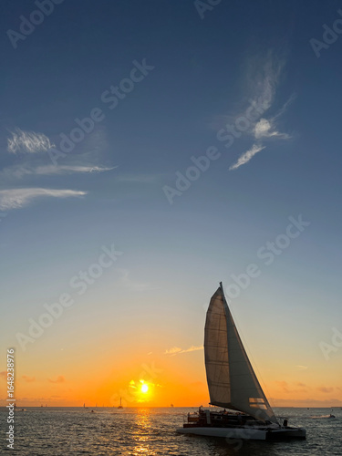 Sailboat at Golden Sunset on Open Ocean
