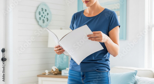 Woman Holding Blank Magazine or Booklet in a Bright Home