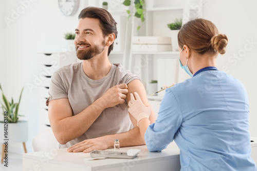 Young man receiving vaccine...