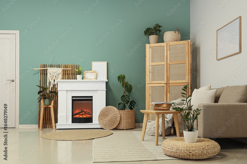 Fototapeta premium Fireplace with sofa, closet and coffee table near turquoise wall in living room