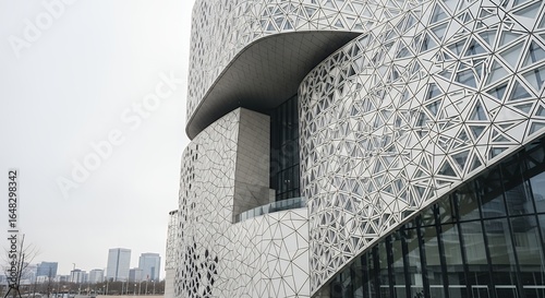 Modern Building Facade with Geometric Triangular Pattern and Curved Design Element