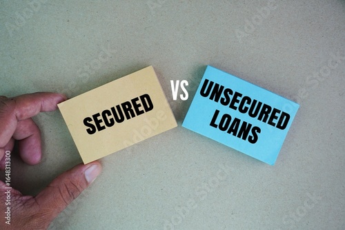 Paper with the words secured vs unsecured loans. Business loans can have better interest rates compared to personal loans
