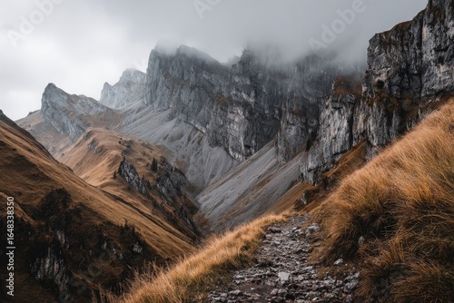 Mountain pass with rocky peaks and a trail