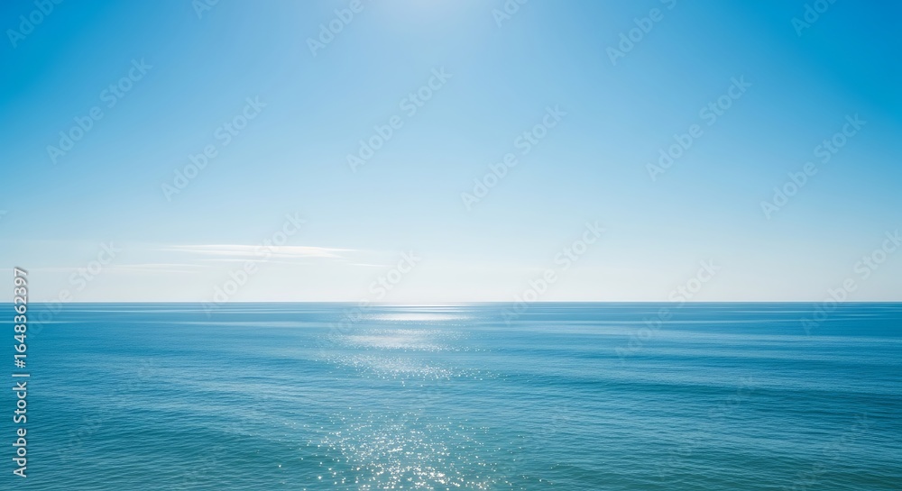 Fototapeta premium Serene seascape featuring clear blue sky and calm ocean on a sunny day landscape scene