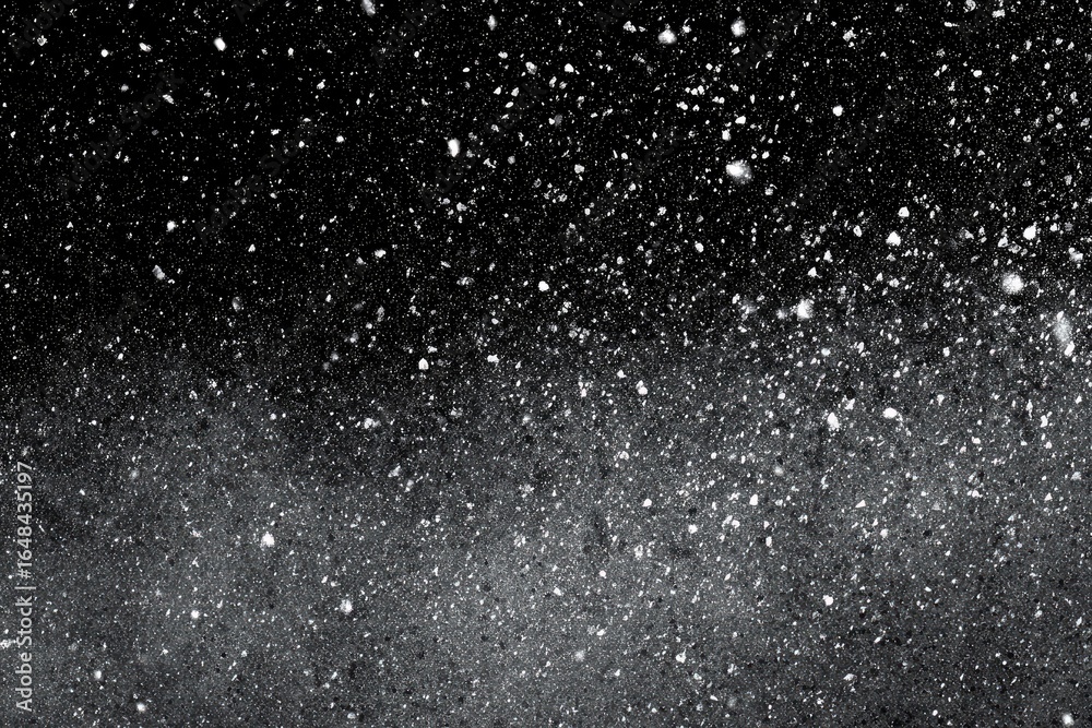 Obraz premium A dark, starry night sky, speckled with falling snow. Gradual transition from black to gray at bottom