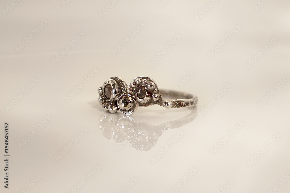 Elegant handmade silver ring with raw gemstones on a white background for stylish women. Elegant handmade silver ring with raw gemstones on a white background for stylish women.
