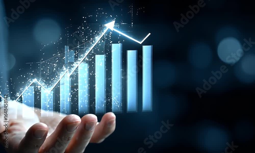 
Hand holding up upward arrows with a business growth graph chart on a blue background for a financial market or online stock trading concept.