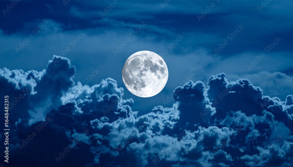 Obraz premium A bright full moon illuminated against a backdrop of dark clouds in a night sky, creating a serene and mystical atmosphere.