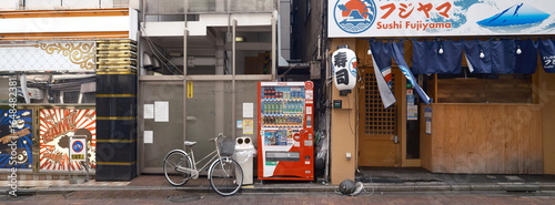 Vending machine and bicycles in a Tokyo nightlife district, Japan