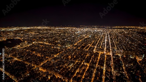 City lights illuminate a sprawling urban landscape at night.
