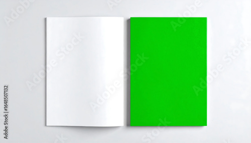 An open book with blank white pages on one side and a solid green page on the other.