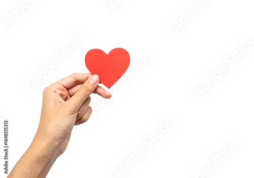 Close-up of a hand holding a red paper heart symbolizing love and compassion against a black