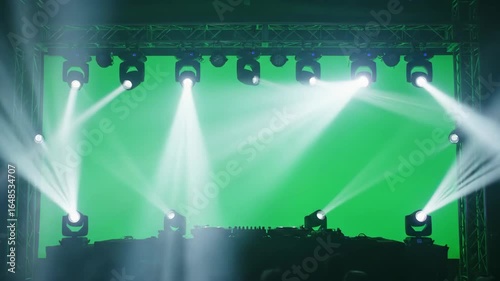 DJ Stage with Green Screen and Spotlights - Multiple spotlights illuminate a DJ stage setup against a vibrant green screen background.