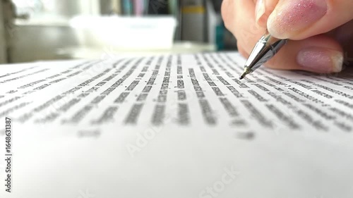 Businesswoman signing a document after reading the agreement in office