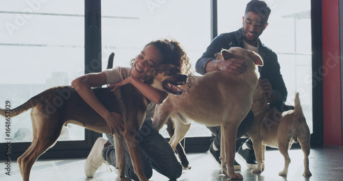 Photography Hug, adoption center and couple with dogs for bonding, companion and care at sanctuary