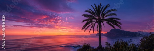 Stunning Palm Tree Silhouette Against Vibrant Sunrise Over Calm Tropical Sea