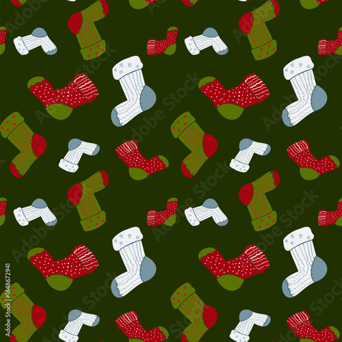 Seamless pattern of stylized knitted socks in red, green, and white scattered on a solid dark green background. Ideal for Christmas and cozy holiday themes.