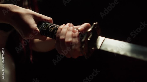 katana wielded by female hands