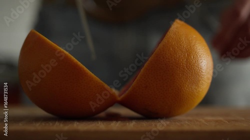 precisely cutting a grapefruit with a large knife
