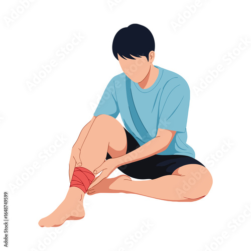 A young man in sportswear sitting down and wrapping his injured ankle with a red elastic bandage.