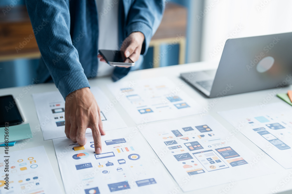 © Charlie's - UX UI Designer Planning innovative Mobile App with Paper Wireframe Designs at Workspace.