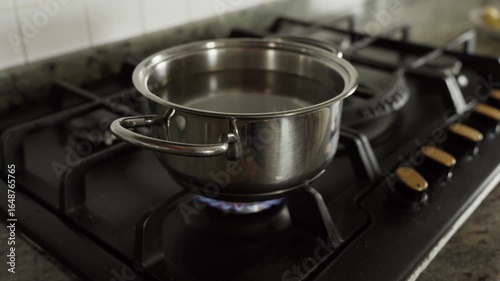 water smoking hot in a pan on a gas stove