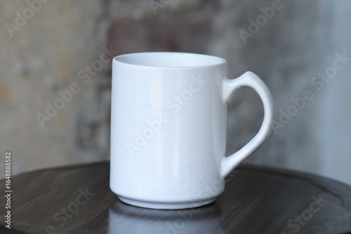 white cup on wooden table