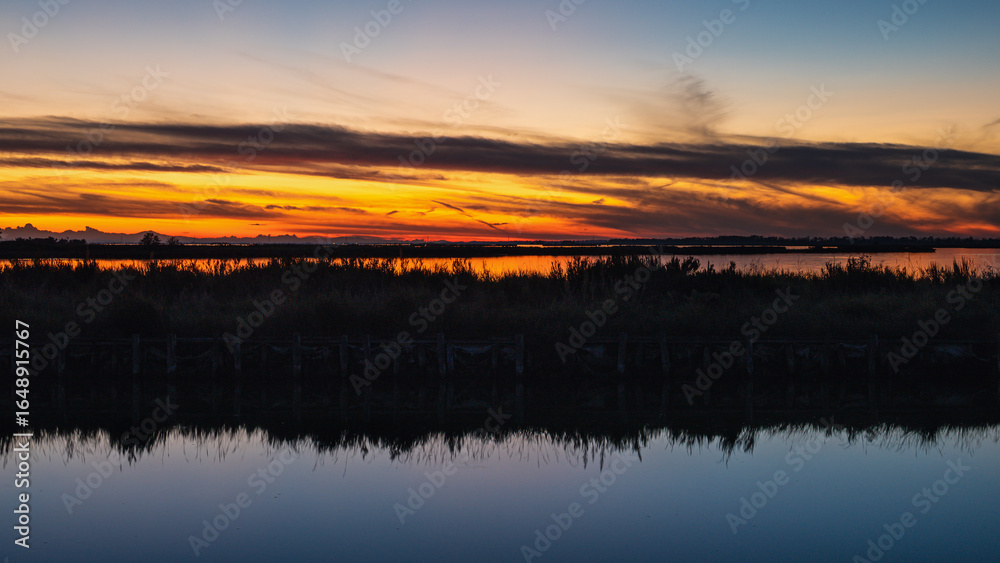 Fototapeta premium sunset over the lagoon, Po river delta, Comacchio, Ferrara, Italy