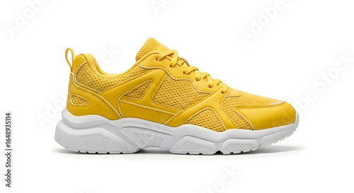 A single yellow fashion sneaker with a chunky sole. Concept of urban style, fitness and casual activewear footwear.