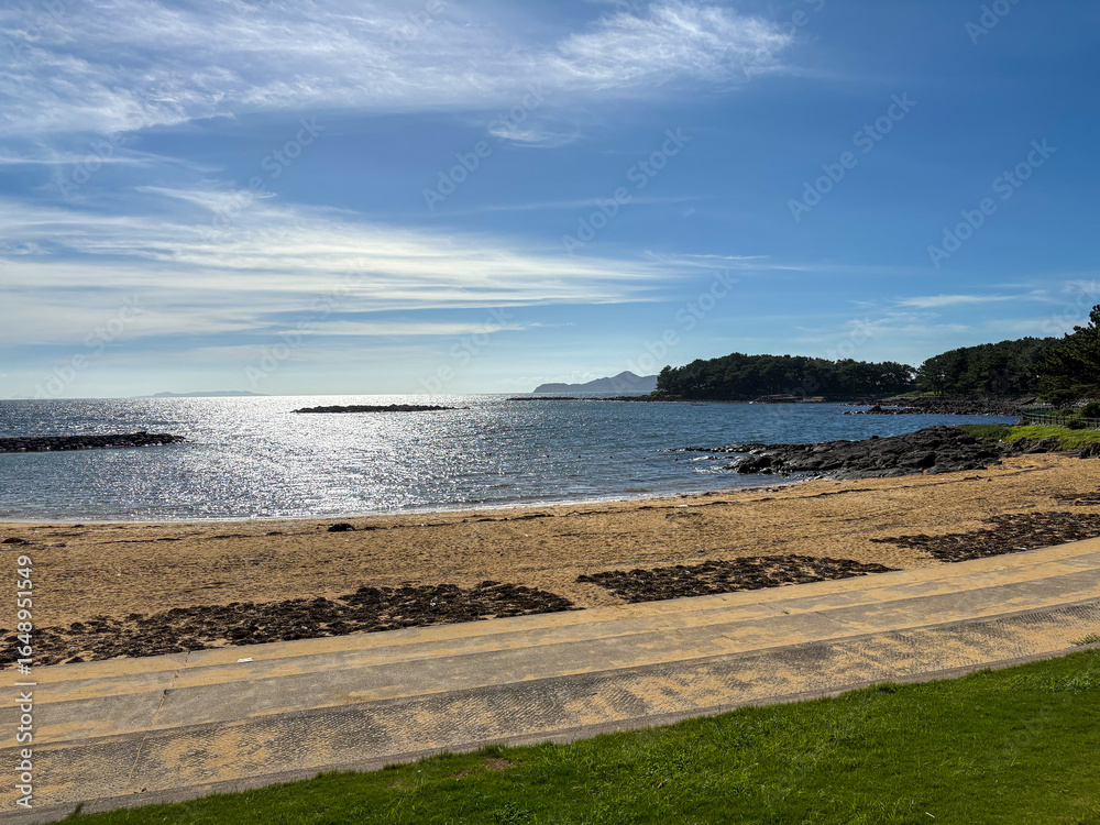 Hado Cape Beach with Sparkling Sea Under Blue Sky Hado Cape Beach with Sparkling Sea Under Blue Sky