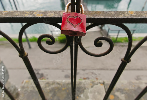 vivid red love lock tied to a gate