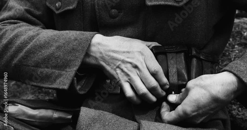 Historical Re-enactment Black And White Video. World War II German Soldier Preparing His Ammunition - Rifle cartridge. Soldier Preparing Weapon. German Military Ammunition Of A German WW2 Soldier