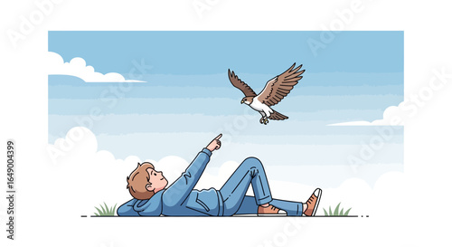 Man Lying On Grass Pointing At A Soaring Hawk In The Blue Sky