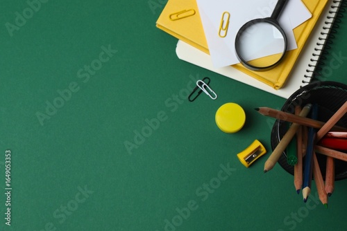 Back to school concept. Top view with school supplies on green background