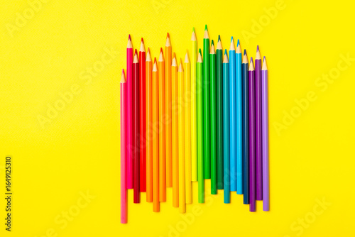 Colored pencils on a bright colored background. Equipment for coloring. Stationery for creativity.Back to school. Flatlay. Children's Creativity and Education. Rainbow.Space for text. Copy space.