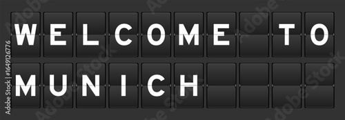 Black color analog flip board with word welcome to munich on gray background