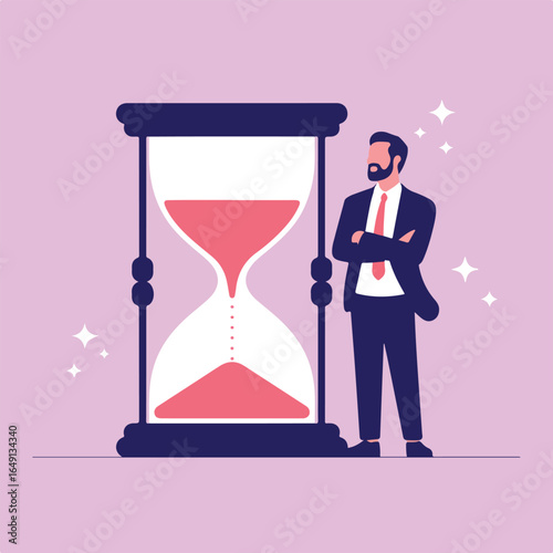 Man in suit standing next to a large hourglass with arms crossed looking at the hourglass time passing